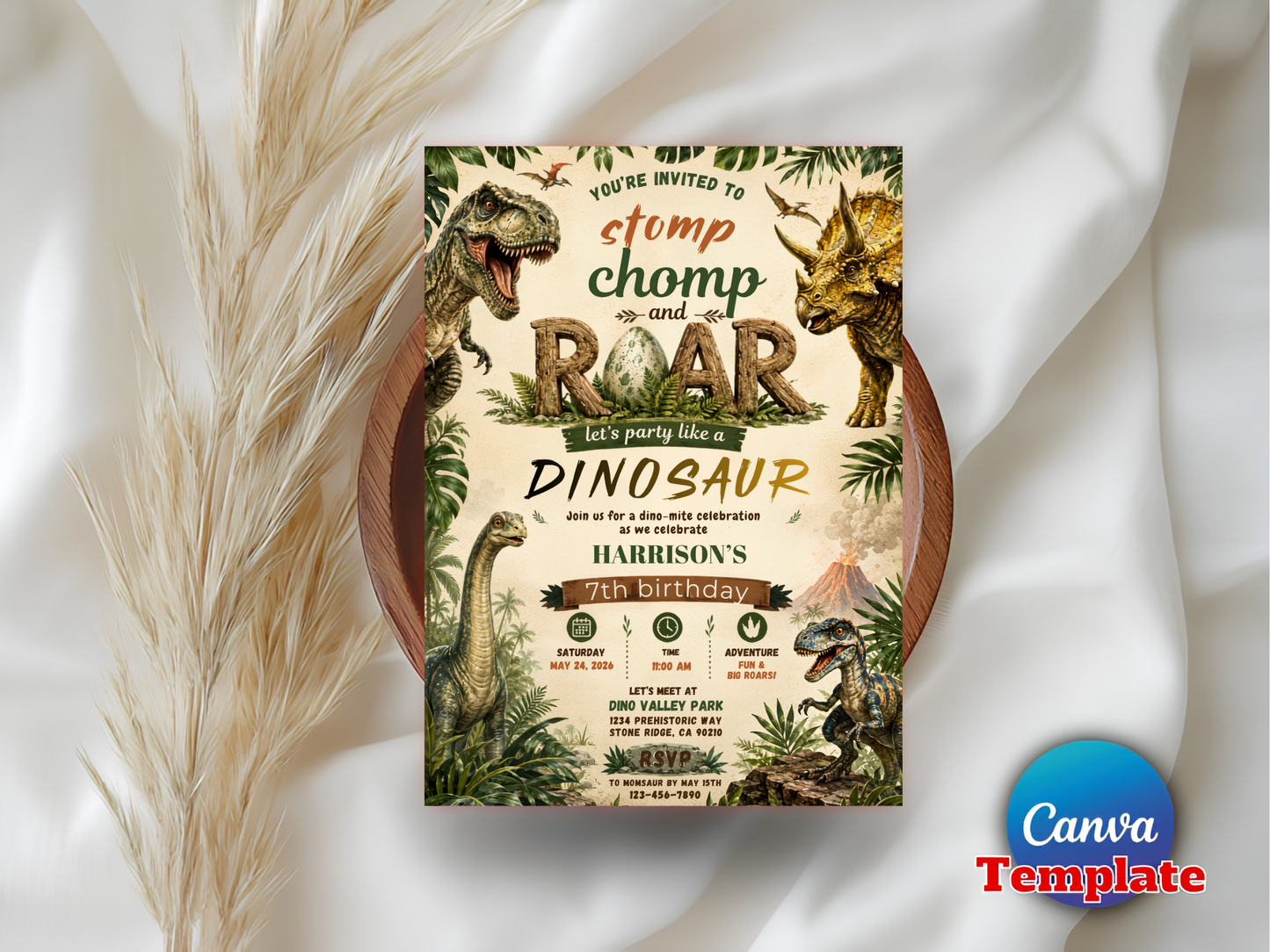 A dinosaur-themed birthday invitation card displayed on a round wooden tray, styled with dried pampas grass on draped white fabric. The card features vintage illustrations of dinosaurs, tropical foliage, and bold text reading 'You're Invited to Stomp Chomp and Roar Dinosaur Birthday'.