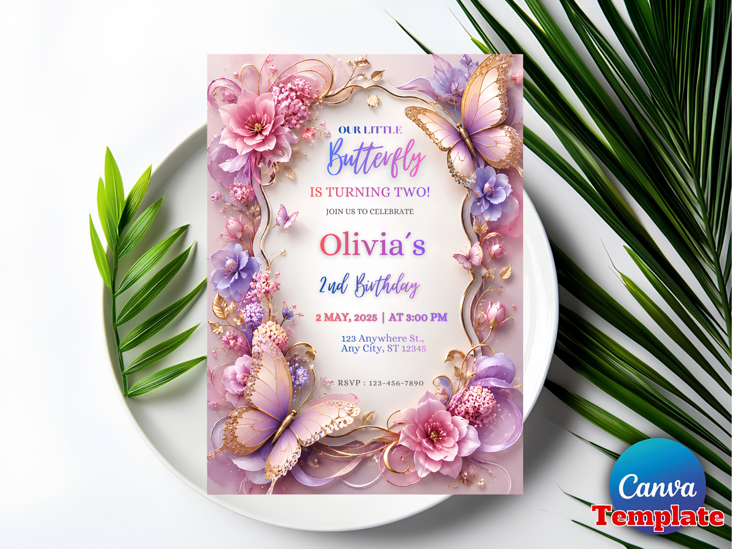 A floral and butterfly-themed birthday invitation card for 'Olivia's 2nd Birthday' styled on a white plate with green palm leaves. The card features pink, purple, and gold illustrations of flowers, butterflies, and a decorative frame.