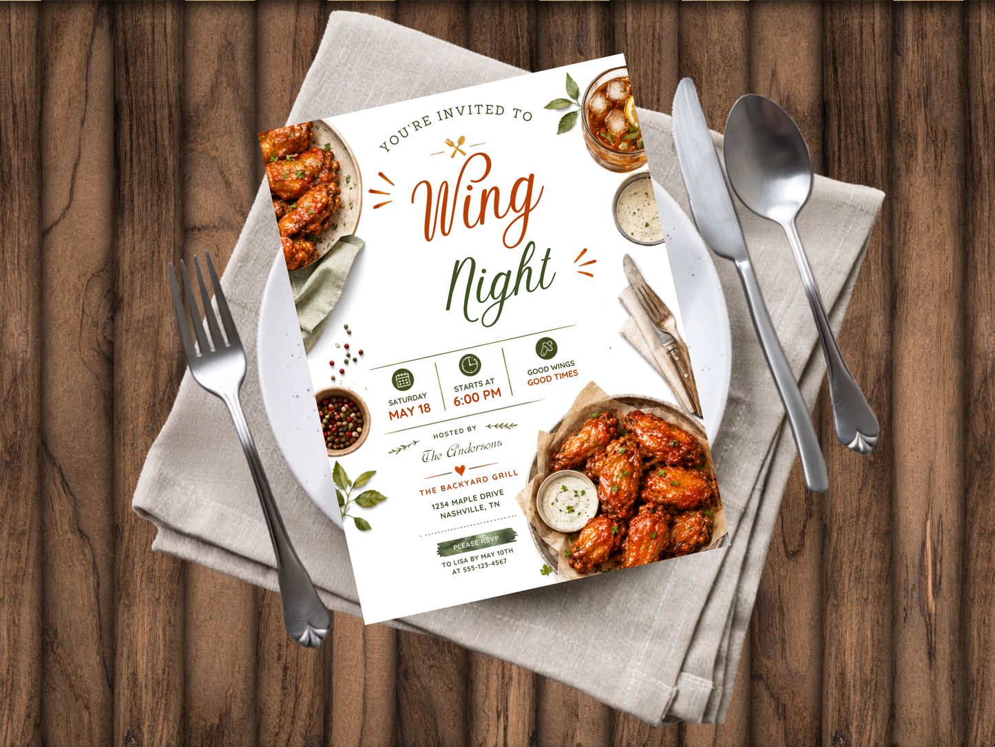 A printed invitation card for a Wing Night event is laid flat on a beige cloth over a wooden table, surrounded by silverware. The card features food photography of buffalo wings and sauce cups with decorative text.