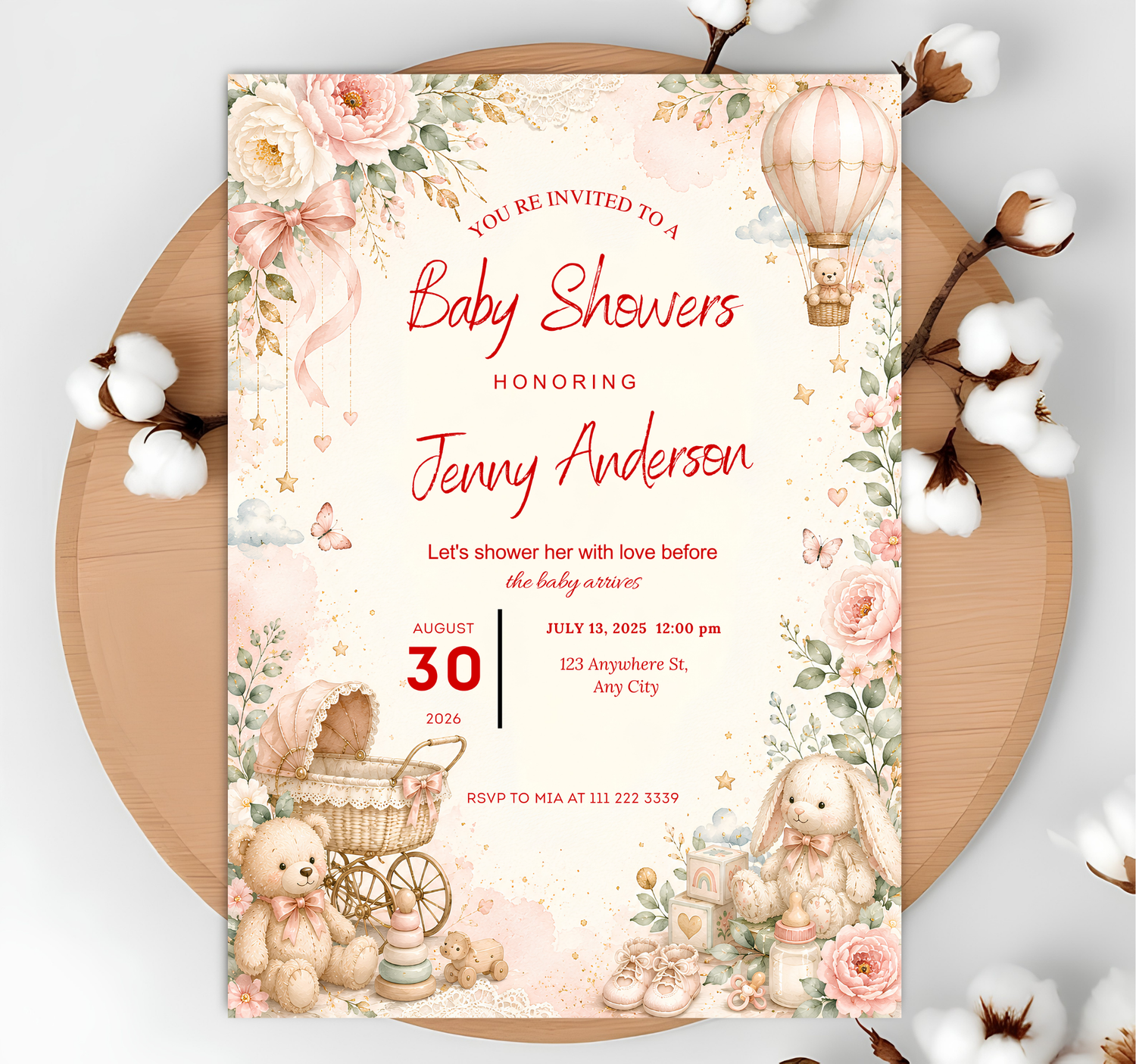 A baby shower invitation card with a vintage-style watercolor design, featuring pink roses, a hot air balloon, teddy bears, a stroller, and a bunny, styled on a round wooden board with cotton bolls.