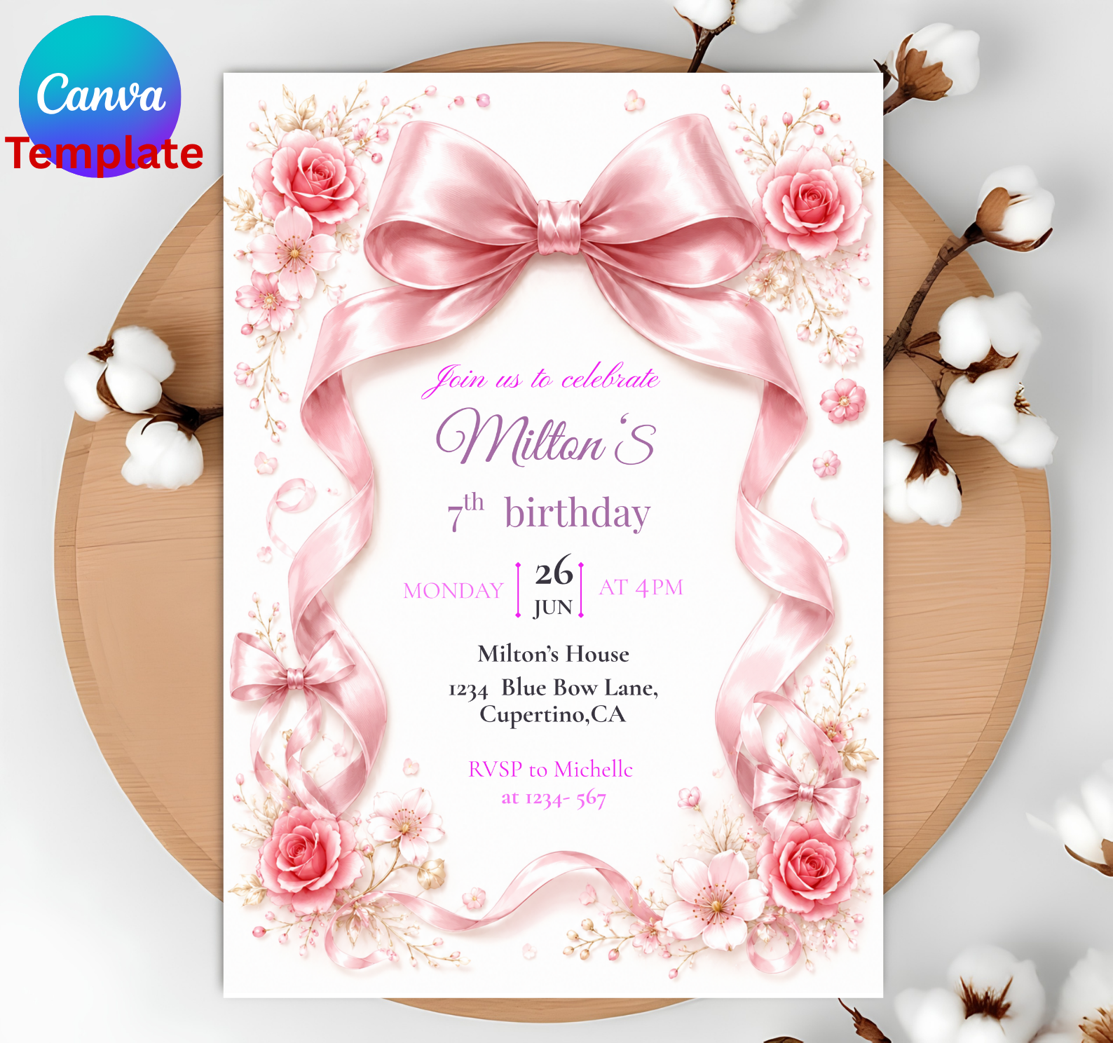 A pink floral birthday invitation card with a large satin bow illustration, shown on a wooden board with cotton bolls. The card includes sample event text and a Canva Template badge in the top-left corner.