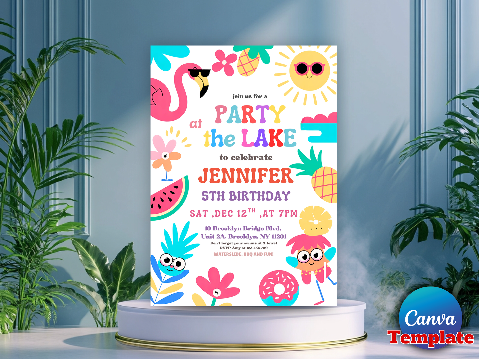 A colorful birthday invitation card for Jennifer's 5th birthday, featuring cartoon flamingos, pineapples, flowers, and a sun on a white background. The card is displayed on a round white pedestal with green plants on both sides against a blue paneled wall.